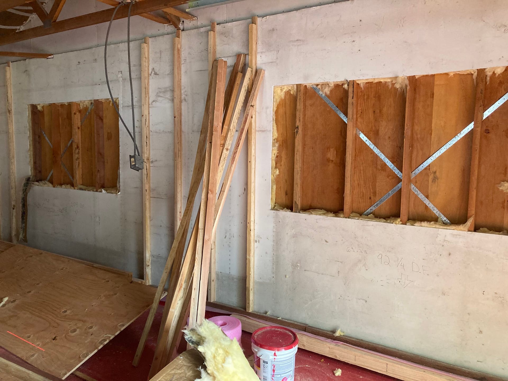 Interior wall demolition showing removed drywall, exposed wood framing, and wall cavities during residential remodeling by On Point Construction.