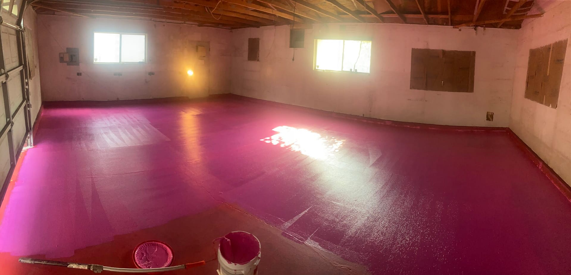 RedGard waterproofing membrane application across a concrete floor during a residential renovation by On Point Construction.
