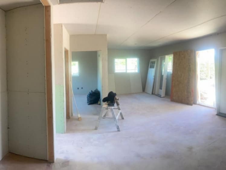 New wall and ceiling drywall installed during an interior build-out before joint finishing.