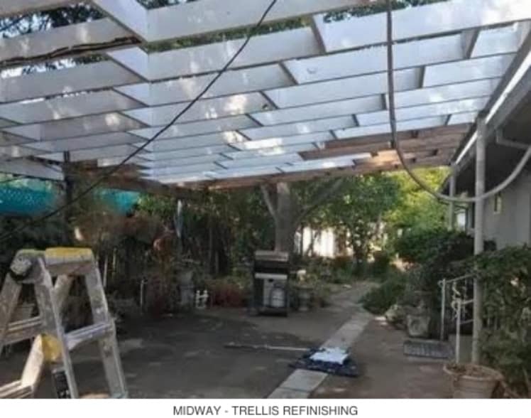 Midway view of trellis refinishing over a backyard patio walkway